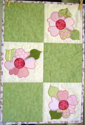 The appliqué design for this quilt comes from the fabric I used in the binding.
