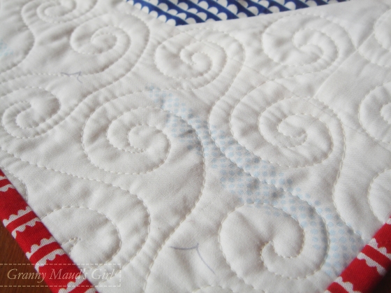 Close up of fabric and swirl quilting