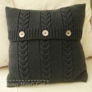 Knitted cushion with cables